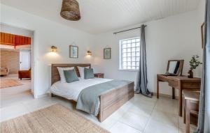a bedroom with a bed and a desk in it at Awesome Home In Arthenac With Wifi in Arthenac