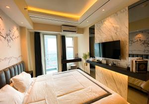 a bedroom with a large bed and a television at Luxury Modern La Casa II Benson in Lontar