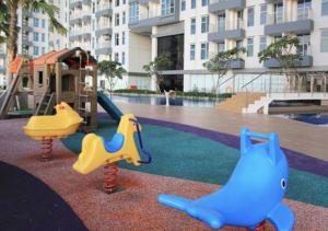 two childrens playground equipment in front of a building at Luxury Modern La Casa II Benson in Lontar