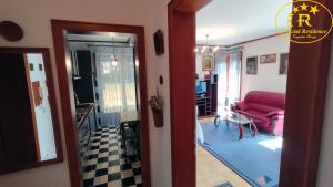 a view of a living room with a red couch at Fractal Residence Apartman Vrnjačka Banja in Vrnjačka Banja