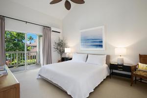 a bedroom with a white bed and a large window at Regency at Poipu Kai 323 in Koloa