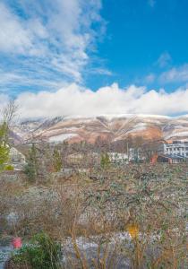 a view of a field with mountains in the background at 16 Greta Grove House in Keswick
