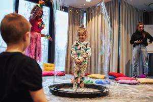 a young child standing on a trampoline in a room at Dune Beach Resort in Mielno