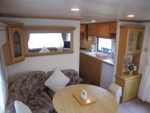 a living room with a couch and a table at 7 Berth on Coral Beach Granada II in Ingoldmells