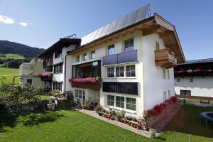 a house with a solarium on the side of it at Appartement Erika in Hopfgarten im Brixental