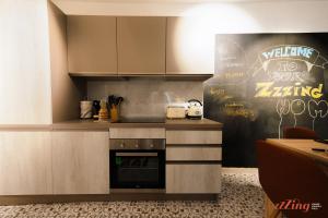 a kitchen with a stove and a wall with graffiti at A modern Maltese townhouse in Siggiewi in Siġġiewi
