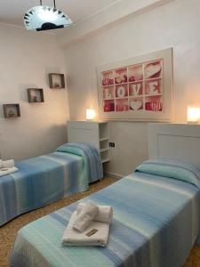 a room with two beds with towels on them at Scicocco Sweet Home in Bagnoli del Trigno
