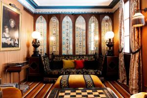 a living room with a couch and a window at H&ocirc;tel Bourg Tibourg - Paris Marais in Paris