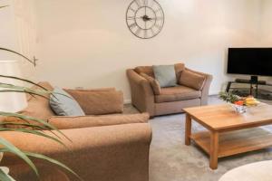 a living room with two couches and a coffee table at Southcliff Retreat in Scarborough