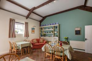 a living room with a table and chairs at East Trewent Farm in Pembroke