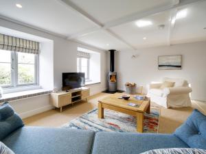 un salon avec un canapé et une table dans l'établissement Joinery Cottage, à Porthleven