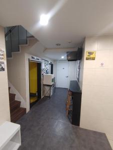 a hallway with a staircase in a room at Joy Guesthouse in Seoul