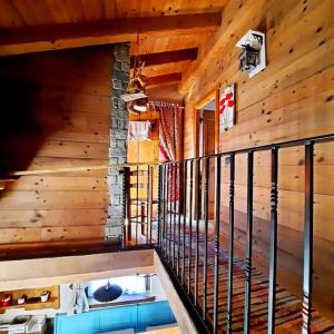 a staircase in a cabin with wooden walls and ceilings at Baita Il Focolare - Your Mountain Holiday in Premana