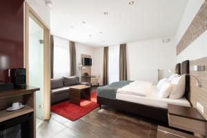 pokój hotelowy z łóżkiem i salonem w obiekcie Hotel Drei Rosen w mieście Moosburg an der Isar
