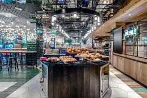 a breakfast buffet in a restaurant with food on a counter at ibis Styles Warszawa Centrum in Warsaw