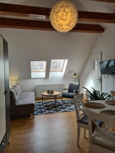 a living room with a couch and a table at Willa Tini Sauna Basen in Gościno