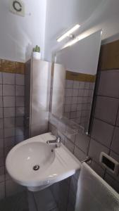 a bathroom with a white sink and a mirror at LechicchediLampedusa in Lampedusa