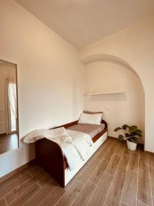 a bedroom with a bed and a potted plant at Agricampeggio La Piaggia - Agriturismo in Piombino