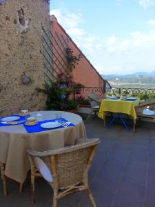 two tables and chairs on a patio with a view at Il Viandante in Santo Stefano di Magra
