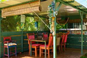a table and chairs sitting on a patio at Les bungalows meublés du Pharest in Sainte-Suzanne