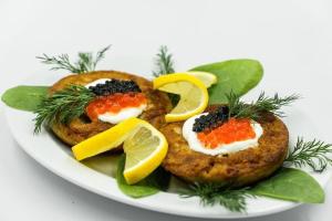 a plate of food with two scones with fruit on it at Hotel Tara in Kielce