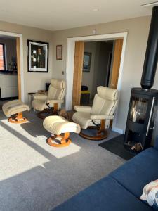 a waiting room with chairs and a fireplace at Sea breeze Exmouth in Lympstone