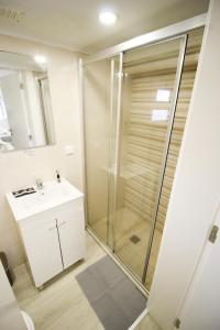 a bathroom with a shower and a sink at Oriente DNA Studios in Lisbon