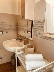 a bathroom with a sink and a mirror and towels at Agricampeggio La Piaggia - Agriturismo in Piombino