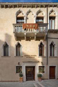 a building with a balcony on top of it at Maison Venezia | UNA Esperienze in Venice