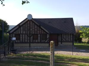 a building with a fence in front of it at GITE LE MONTENEY in Pont-Audemer