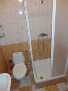 a bathroom with a toilet and a shower with a shower at Pensjonat Aida in Kołobrzeg