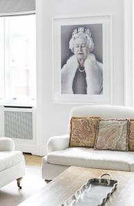 a living room with a king picture on the wall at The Connaught Suite in London