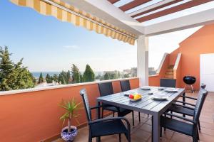 taras ze stołem i krzesłami na balkonie w obiekcie Cozy penthouse in Torremolinos by Costarentals - Ref 09 w mieście Torremolinos