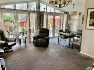 a living room with a chair and a dining room at Rannoch Lodge in Auchterarder