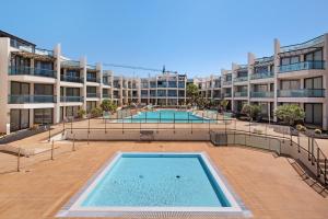 a large swimming pool in the middle of a building at Apartamento Nautilus sea view in El Cotillo