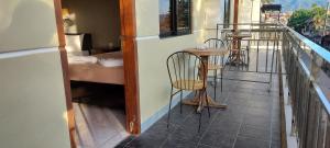 a balcony with two chairs and a table on a building at Coron Vista Lodge in Coron