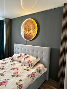 a bedroom with a bed with a planet on the wall at Apartamente A&A in Tîrgu Ocna