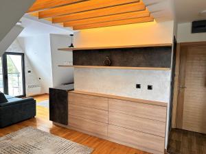a living room with a wall with wooden shelves at Lexi Bombonjera apartman in Divčibare