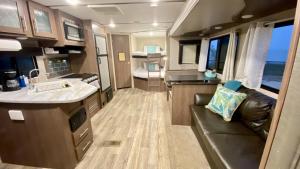 a kitchen and living room of an rv at Glamping on the Bay with fishing dock in Bolivar Peninsula