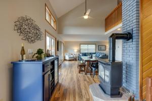 eine Küche und ein Wohnzimmer mit einem Holzofen in der Unterkunft Spacious Hammondsport Home on 6 Acres with Lake View in Hammondsport