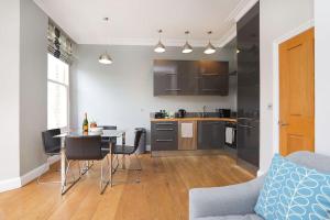 a kitchen and living room with a table and chairs at Comfy 1 bed flat in Tufnell Park in London