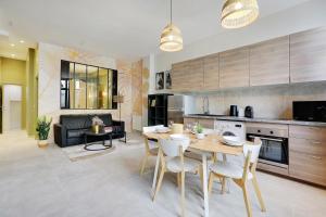 eine Küche und ein Wohnzimmer mit einem Tisch und Stühlen in der Unterkunft CMG Ramey / Sacré-Coeur III in Paris