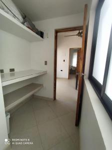 an empty room with a door and a hallway at Casa Suite Palmar del viento FRENTE, FRENTE AL MAR in Moñitos