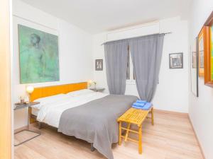 a bedroom with a large bed and a table at Apartment Eixample Dret Independencia Valenci by Interhome in Barcelona