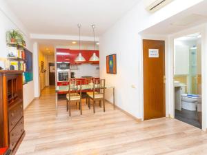 a kitchen and dining room with a table and chairs at Apartment Eixample Dret Independencia Valenci by Interhome in Barcelona