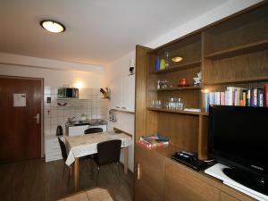 a small kitchen with a small table and a television at Apartment Biegel-Kraus by Interhome in Steinach am Brenner