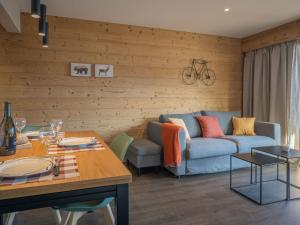a living room with a couch and a table at Apartment Plein Soleil A 9 by Interhome in Ovronnaz