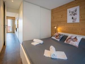a bedroom with two beds with towels on it at Apartment Plein Soleil A 9 by Interhome in Ovronnaz