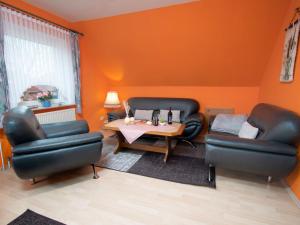 ein Wohnzimmer mit 2 Ledersesseln und einem Tisch in der Unterkunft Apartment Schonerweg by Interhome in Norddeich
