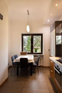 a kitchen with a table and chairs in a room at ClickTheFlat Legionowo Apart Rooms in Legionowo +24 photos